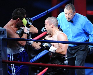 PITTSBURGH, PENNSYLVANIA - JULY 11, 2014: Jake Giuriceo throws a punch to the body of Travis Hartman during a welterweight bout Friday night at Rivers Casino. Giuriceo would win via 4th round TKO. (Photo by David Dermer/Youngstown Vindicator)