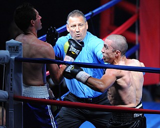 PITTSBURGH, PENNSYLVANIA - JULY 11, 2014: Referee Chris Riskys steps in to end the fight while Jake Giuriceo throws one final punch at Travis Hartman during a welterweight bout Friday night at Rivers Casino. Giuriceo would win via 4th round TKO. (Photo by David Dermer/Youngstown Vindicator)