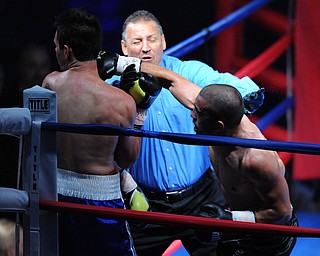 PITTSBURGH, PENNSYLVANIA - JULY 11, 2014: Referee Chris Riskys steps in to end the fight while Jake Giuriceo throws one final punch at Travis Hartman during a welterweight bout Friday night at Rivers Casino. Giuriceo would win via 4th round TKO. (Photo by David Dermer/Youngstown Vindicator)