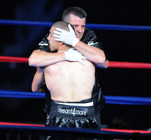 PITTSBURGH, PENNSYLVANIA - JULY 11, 2014: Trainer Keith Burnside congratulates Jake Giuriceo after a referee stoppage at the center of the ring after a welterweight bout Friday night at Rivers Casino. Giuriceo would win via 4th round TKO. (Photo by David Dermer/Youngstown Vindicator)