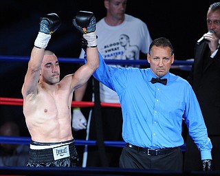 PITTSBURGH, PENNSYLVANIA - JULY 11, 2014: Jake Giuriceo has his arm raised in victory by referee Chris Riskys in the center of the ring after a welterweight bout Friday night at Rivers Casino. Giuriceo would win via 4th round TKO. (Photo by David Dermer/Youngstown Vindicator) Trainer Keith Burnside pictured.