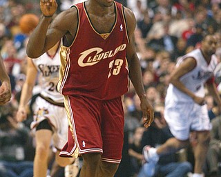 Cleveland Cavaliers' LeBron James holds up a finger after making a 3-point shot against the Philadelphia 76ers during the third quarter Friday, Dec. 19, 2003, in Philadelphia. (AP Photo/Rusty Kennedy)