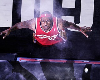 Cleveland Cavaliers forward LeBron James (23) blows the powder he tossed in to the air prior to the team's NBA basketball game againswt the San Antonio Spurs in San Antonio, Friday, Feb. 27, 2009. (AP Photo/Eric Gay)