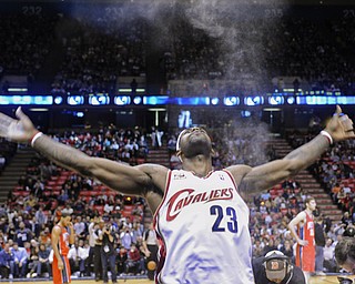 Cleveland Cavaliers' LeBron James throws powder into the air duriing an NBA basketball game against the New Jersey Nets on Saturday, Jan. 2, 2010 in East Rutherford, N.J. (AP Photo/Bill Kostroun)