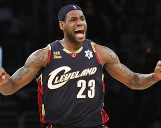 FILE - In this Dec. 25, 2009 file photo, Cleveland Cavaliers forward LeBron James reacts during the second half against the Los Angeles Lakers in an NBA basketball game in Los Angeles. James told Sports Illustrated on Friday, July 11, 2014, he is leaving the Miami Heat to go back to the Cleveland Cavaliers. (AP Photo/Lori Shepler, File)