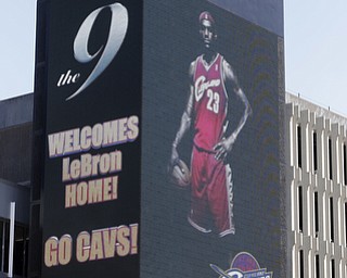 A large electronic billboard in Cleveland welcomes back NBA basketball star LeBron James Friday, July 11, 2014, after he announced he would return to the Cleveland Cavaliers after four years with the Miami Heat. (AP Photo/Mark Duncan)