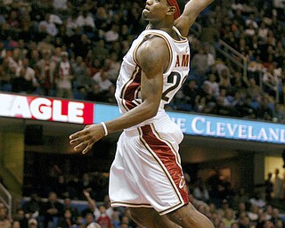 **FILE** Cleveland Cavaliers' LeBron James goes up for a dunk against the Philadelphia 76ers in this Nov. 15, 2003 file photo, in Cleveland. Nike, which spent $90 million securing the player's endorsement, hopes to make his footwear the new Air Jordan. (AP Photo/Mark Duncan, File)