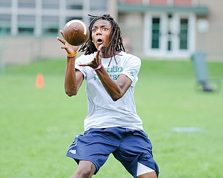 Tristan Ballad of Youngstown catches a pass during a receiver drill at Ursuline’s football camp Monday morning
at Ursuline High School.