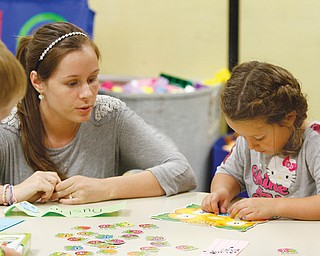 Success By 6 teacher Cara Diana and Kaylee Black, who is entering kindergarten in the fall, work on the alphabet during the United Way of Youngstown and the Mahoning Valley preschool program at Hilltop Elementary School in Canfield.