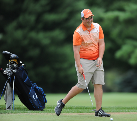 WARREN, OHIO - JULY 16, 2014: Cameron Gumble of Austintown smiles while lining up his putt on the 5th hole Wednesday afternoon at Trumbull Country Club during the Vindy Greatest Golfer tournament. (Photo by David Dermer/Youngstown Vindicator)