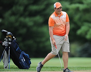 WARREN, OHIO - JULY 16, 2014: Cameron Gumble of Austintown smiles while lining up his putt on the 5th hole Wednesday afternoon at Trumbull Country Club during the Vindy Greatest Golfer tournament. (Photo by David Dermer/Youngstown Vindicator)