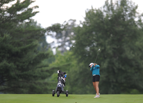 WARREN, OHIO - JULY 16, 2014: Nicolette Eddy of Niles follows through on her approach shot on the 2nd hole Wednesday afternoon at Trumbull Country Club during the Vindy Greatest Golfer tournament. (Photo by David Dermer/Youngstown Vindicator)