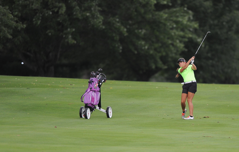 WARREN, OHIO - JULY 16, 2014: Nicole Gula of Howland follows through on her approach shot on the 2nd hole Wednesday afternoon at Trumbull Country Club during the Vindy Greatest Golfer tournament. (Photo by David Dermer/Youngstown Vindicator)