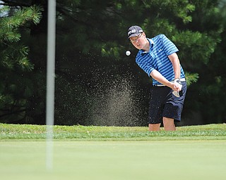 Zach Jacobson of Poland hits out of the sand onto the No. 3 green at Trumbull Country Club in Warren during Wednesday’s final qualifier for The Greatest Golfer of the Valley Juniors tournament. The final is July 27 at Avalon Lakes Golf & Country Club in Howland.