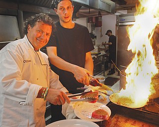 Ottavio Musumeci, owner and head chef at Station Square Ristorante in Liberty, at left, and cook Gerry Gianoutsos work in the kitchen at the restaurant. The eatery offers American and Italian cuisine with organic, grass-fed beef offered, among other items. The menu also has multiple gluten-free options.