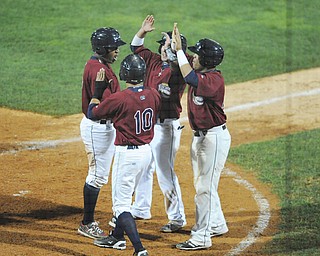 The Scrappers’ Leo Castillo, left, is mobbed by teammates, including Yonathan Mendoza, Drake Roberts and Steven Patterson after hitting a game-tying grand slam in the eighth inning of Thursday’s New York-Penn League game against the Connecticut Tigers at Eastwood Field in Niles. Mahoning Valley fell 10-9 in the 14th.