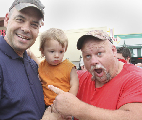 william D. Lewis The Vindicator  Fat and Furious cast member Steve McGranahan, right, poses for a photo with Adam Earnheardt of Liberty and his son Oscar, 20 months during a car show at Quaker Steak and Lube in Boardman 7-18-14.