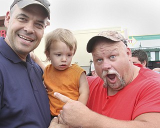 william D. Lewis The Vindicator  Fat and Furious cast member Steve McGranahan, right, poses for a photo with Adam Earnheardt of Liberty and his son Oscar, 20 months during a car show at Quaker Steak and Lube in Boardman 7-18-14.
