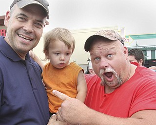 william D. Lewis The Vindicator Fat and Furious cast member Steve McGranahan, right, poses for a photo with Adam Earnheardt of Liberty and his son Oscar, 20 months during a car show at Quaker Steak and Lube in Boardman 7-18-14.