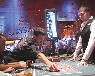 A dealer watches as gamblers place bets on a roulette table at Revel Casino Hotel in Atlantic City, N.J. Revel is one of three Atlantic City casinos that could close by September in a wave of casino contraction that could be a glimpse of the future for other parts of the country with too many casinos and not enough gamblers to support them.