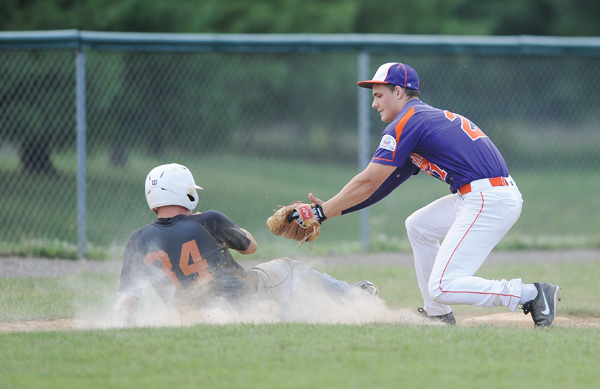 Creekside infielder Alex Harrison prepares to tag the Longhorns’ Owen Dobbins during a pickoff in Sunday’s Colt championship game at Cene Park in Struthers.