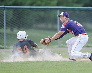Creekside infielder Alex Harrison prepares to tag the Longhorns’ Owen Dobbins during a pickoff in Sunday’s Colt championship game at Cene Park in Struthers.
