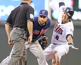 Twins baserunner Kurt Suzuki, right, is tagged out by Indians second baseman Jason Kipnis as he tried to stretch a single into a double during Monday’s game in Minneapolis.