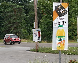 Advertising signs are illegally posted at this convenience store at Market Street and Roche Way in Boardman and on many other roads in the township. Utility poles are government property and, therefore, business owners are not permitted to post signs on them.