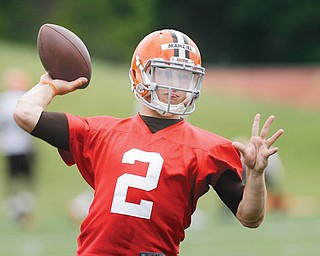 Cleveland Browns quarterback Johnny Manziel passes during a mandatory minicamp practice at the team’s facility in Berea. After months of having his off-field behavior analyzed, scrutinized and criticized, Manziel will again be the center of attention as he battles veteran Brian Hoyer for the Browns’ starting QB job.