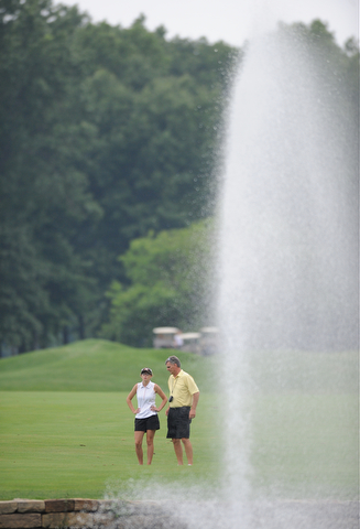 WARREN, OHIO - JULY 27, 2014: Emily Koehler and her caddie James Koehler examine the fairway and green before her shot on the 9th hole Sunday afternoon at Avalon Lakes Country Club during the Vindy Greatest Golfer Tournament. (Photo by David Dermer/Youngstown Vindicator)