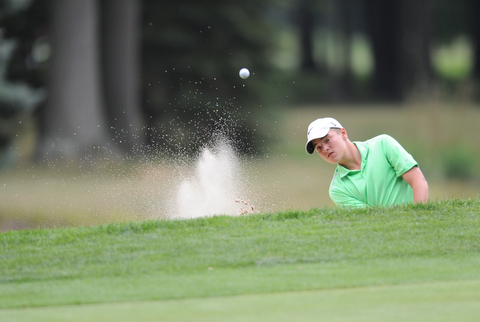 WARREN, OHIO - JULY 27, 2014: Jimmy Graham chips out of the bunker on the 3rd hole Sunday afternoon at Avalon Lakes Country Club during the Vindy Greatest Golfer Tournament. (Photo by David Dermer/Youngstown Vindicator)