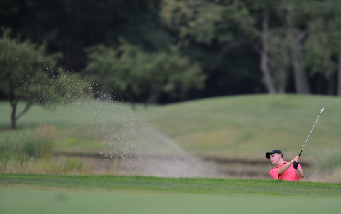 WARREN, OHIO - JULY 27, 2014: Bradley Miller follows through on a shot out of the bunker on the 14th hole Sunday afternoon at Avalon Lakes Country Club during the Vindy Greatest Golfer Tournament. (Photo by David Dermer/Youngstown Vindicator)