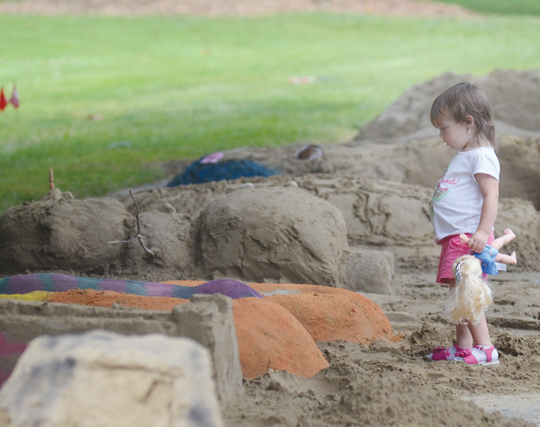 Casey Malloy, 2, looks at sand sculptures at Sun Fest at Mill Creek Metro Parks in Youngstown on Sunday. The all-day event at the James Wick Recreation Area featured a variety of activities for families.