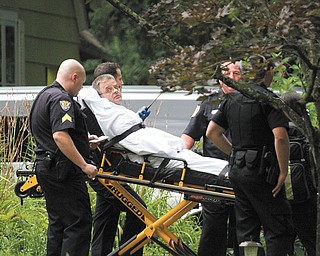 Glenn Fulton, 50, of Youngstown, accused of leading police on a  high-speed chase and barricading himself in a Kiwatha Road home, is moved on a stretcher after negotiations with police.