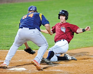 Scrappers baserunner Austin Fisher is tagged out by State College pitcher Kyle Grana when Fisher tried to score on a passed ball in Monday’s game at Eastwood Field in Niles.
