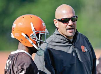 Browns head coach Mike Pettine talks with wide receiver Chandler Jones during practice at the team’s training camp in Berea.