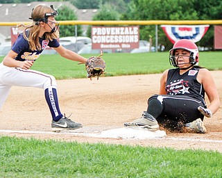 Canfield baserunner Lauren Fitzgerald is safe at third base during Tuesday’s 4-0 win over Tallmadge. Defending is Tallmadge’s Gia Casalinova.