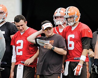 Browns quarterbacks coach Dowell Loggains, center, talks to QBs Brian Hoyer (6) and Johnny Manziel (2) during Sunday’s practice in Berea. Training camp is less than a week old and Manziel is finding things behind center are not as easy for him as they were when he was at Texas A&M.