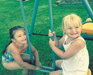 Sophia Barringer and Addison Shotts, cousins, are playing at a picnic at Nana's house in North Jackson. Nana is also known as Barbara Barringer.