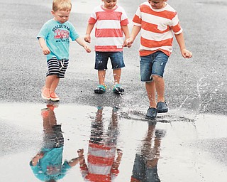 Sam Manning, 4; Leo Manning, 2; and Owen Holt, 1 1/2, are ready to step right in the puddle at Bethany Beach.