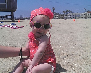California Beach Baby is sitting pretty (with help from her mommy, Brittany Jenkins). Four-month-old Kyra smiles at her grandma, Wendy Jenkins, who took this photo at Seal Beach, Calif. All are Boardman residents. Great-gma Peg Sigle of Boardman submitted the photo.