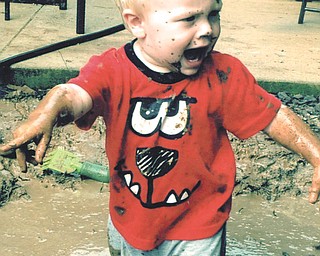 If you don't have a kiddie pool, a rain puddle will do for Hunter Massie of San Antonio. Submitted by grandparents Joe and Linda Massie of Boardman.