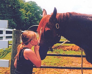 Grace Burchfield, 9, of New MIddletown, giving Henry a kiss. She helps her cousin Kelly Snyder take care of the horse. Sent by her mom, Bethany Paulin.