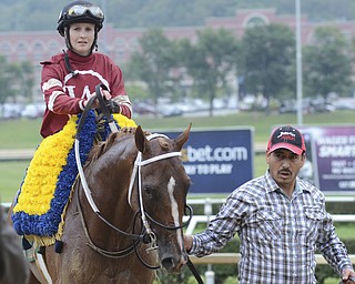 Katie Rickman | The Vindicator.Rosie Napravnik and Tapiture are led on the track after winning the West Virginia Derby August 2, 2014.
