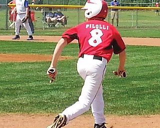 Dominic Pilolli of Canfield’s 11-12 Little League Baseball team takes off from first base during Sunday’s game gainst Midland, Mich., at the Great Lakes Regional tournament at Ferguson Field in Indianapolis. Canfield ousted
Midland, 8-1, with help from Pilolli, who ignited a five-run rally with a two-out double in the third inning. Canfield faces Kentucky today in more pool play.