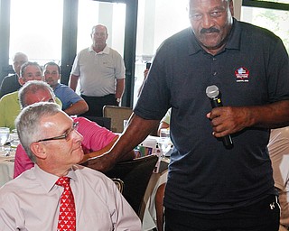 Pro Football Hall of Famer Jim Brown, right, speaks during the Youngstown Phantoms Sticks to Clubs banquet
on Monday at The Lake Club in Poland. At left is Youngstown State president Jim Tressel.