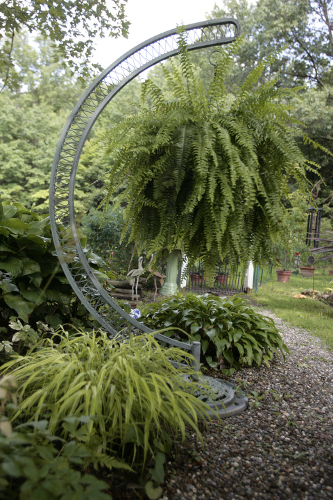        ROBERT K. YOSAY  | THE VINDICATOR.. Our Lady of the Lakes Parish-- has an oasis for solitude or just reflection or just enjoying the flowers as the Rev. David W. Merweiler is pastor and gardener.....  -30-