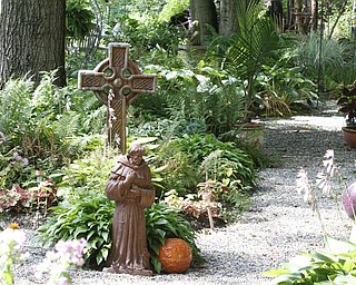 ROBERT K. YOSAY | THE VINDICATOR.. a pathway at the Our Lady of the Lakes Parish-- has an oasis for solitude or just reflection or just enjoying the flowers as the Rev. David W. Merweiler is pastor and gardener..... -30-