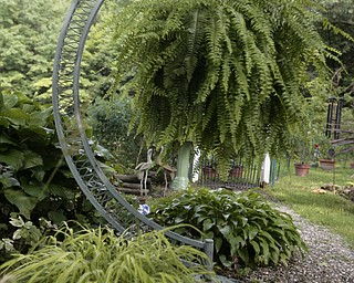 ROBERT K. YOSAY | THE VINDICATOR.. Our Lady of the Lakes Parish-- has an oasis for solitude or just reflection or just enjoying the flowers as the Rev. David W. Merweiler is pastor and gardener..... -30-