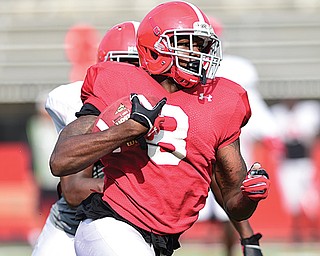 Youngstown State receiver Jelani Berassa (8) looks for daylight after getting behind defensive back D.J. Thomas during Tuesday’s practice at Stambaugh Stadium.